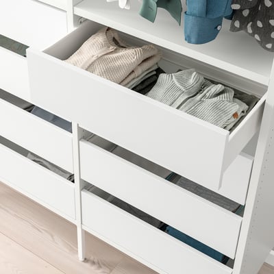 White wardrobe with open drawers showing neatly folded clothes. Part of the AURDAL storage system, ideal for organising garments efficiently.