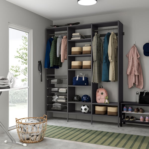 Organised AURDAL closet with shelves, rods, shoe rack, rug, and laundry basket.
