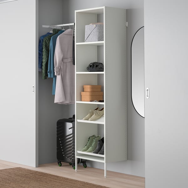 White AURDAL storage unit with shelves and hanging rod in closet.