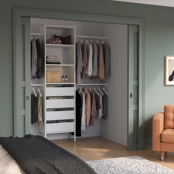 Organised AURDAL storage in closet, white drawers, clothes, cosy atmosphere.