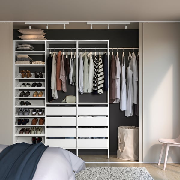 Organised walk-in closet with AURDAL shelves and chair.