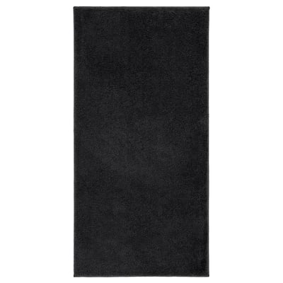 Black rectangular bath mat, soft & absorbent, made from recycled polyester, latex backing.