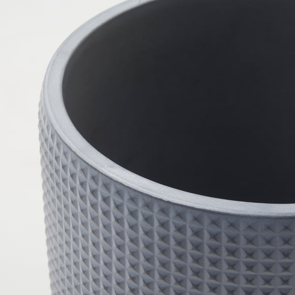 Textured grey concrete planter with diamond pattern; smooth interior.
