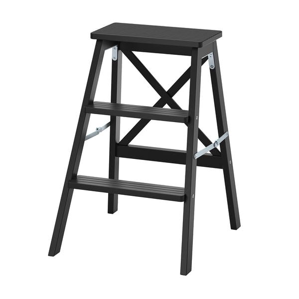 Black wooden folding step stool in flat position, rectangular top with two steps and x-shaped supports.
