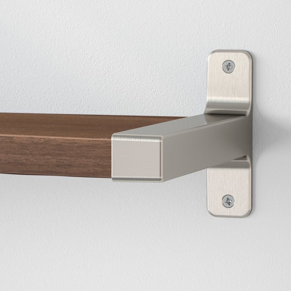 Modern wall shelf mounted with metal brackets. Sleek design, sturdy construction, suitable for various spaces.
