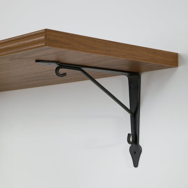 Wooden wall shelf mounted with sturdy metal brackets, displaying robust craftsmanship.