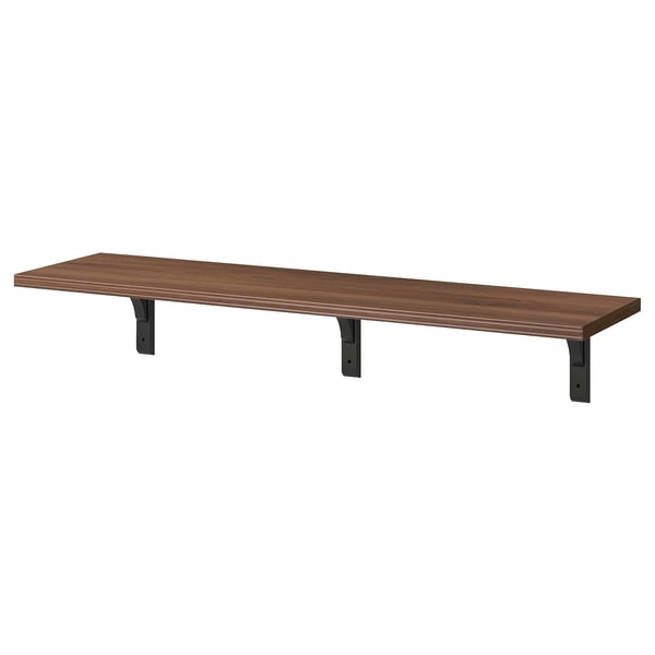 A BERGSHULT wall shelf in dark brown, supported by three black brackets. It has a bevelled and smooth edge design.