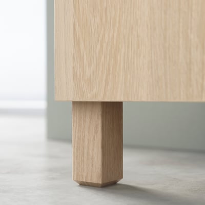 Wooden table leg in natural colour; square shape, smooth finish.