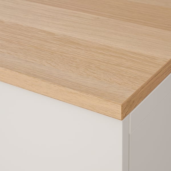 Close-up of high-quality wooden table top, smoothly finished and neatly aligned with a crisp white edge.