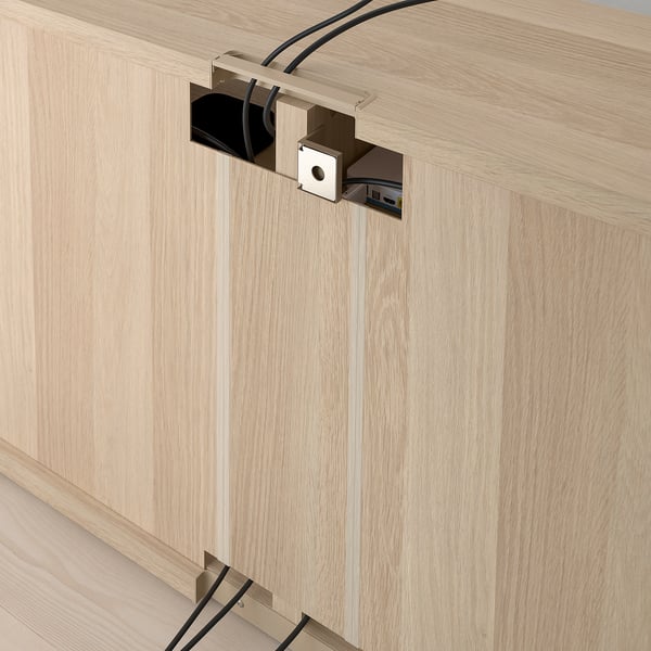 Wooden tv bench with adjustable feet and cable management system, showcasing integrated power and data outlets at the back for organising electronics.