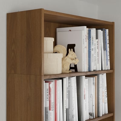 Wooden bookshelf with multiple shelves filled with books, including a unique wooden bookend shaped like a horse.