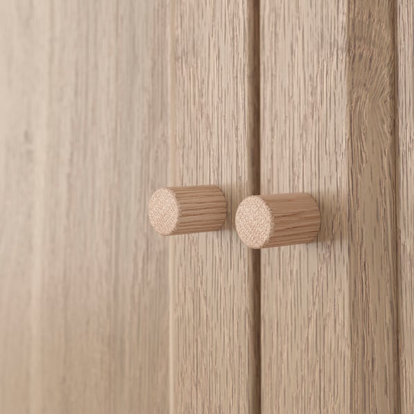 Light wood doors with cylindrical handles, smooth finish, natural light wood grain visible, elegant craftsmanship.