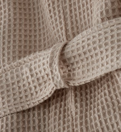 Close-up of soft, waffle-weave bathrobe, showcasing its texture and quality.