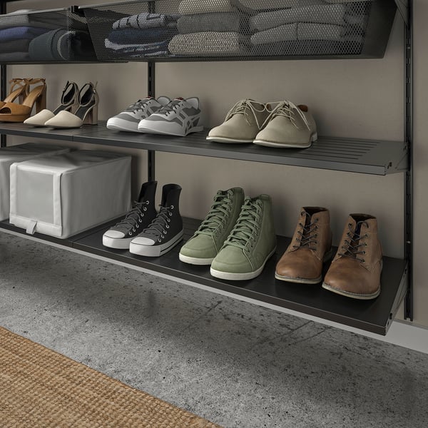 Shoe rack with various footwear: heels, flats, sandals, trainers, boots.
