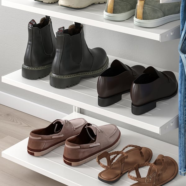 Shelves with shoes: sandals, boots, dress shoes, trainers.