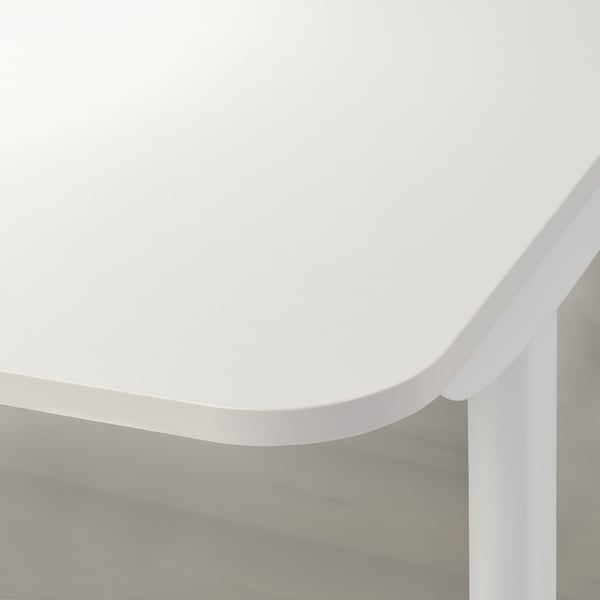 White desk edge detail, smooth and modern, sturdy design.