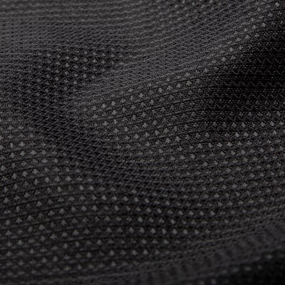 Close-up of textured black fabric, revealing intricate waffle pattern, showcasing quality and depth.