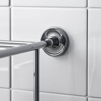 Towel rail on tiled wall with screws.