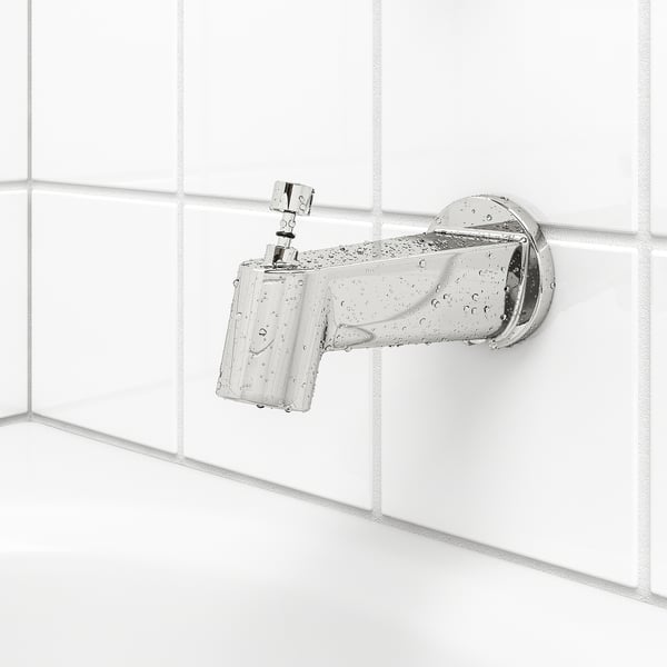 Chrome shower tap on tiled wall with spray functions, droplets indicate use.