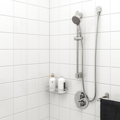 Chrome BROGRUND hand shower with flexible hose on white wall, small glass shelf below. Or chrome hand shower with hose, small shelf below.