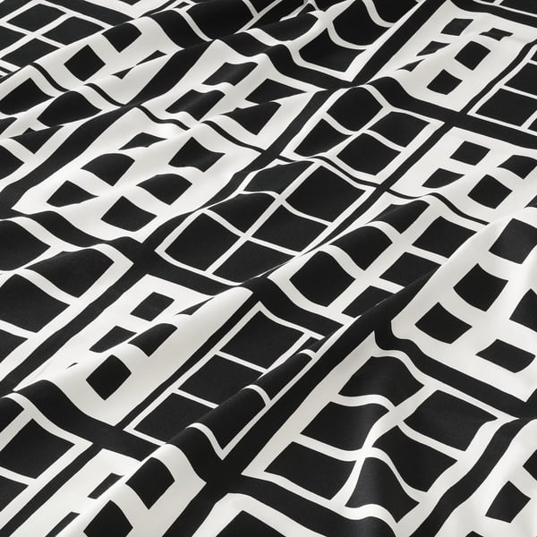 Black and white geometric pre-cut fabric with intricate patterns, suitable for crafts and sewing projects.