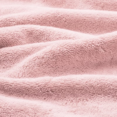 Close-up of soft, light pink, plush towels with a textured weave, showcasing their high-qualityabsorbent material.