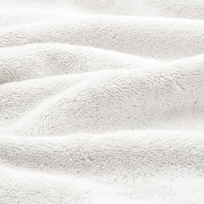 Soft, plush towels with an intricate, woven border, showcasing high-quality craftsmanship.