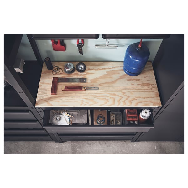 Black metal storage unit with wooden top, holding various tools and items, including a blue gas cylinder and red-handled shears.