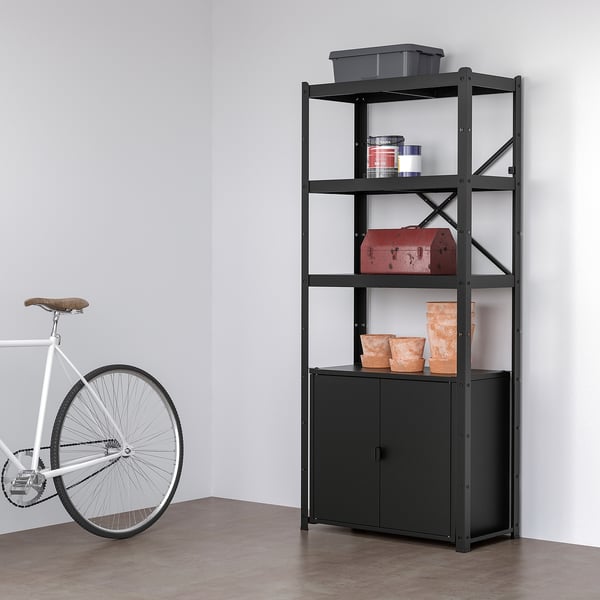 Black BROR shelf with tools & pots next to white bike.