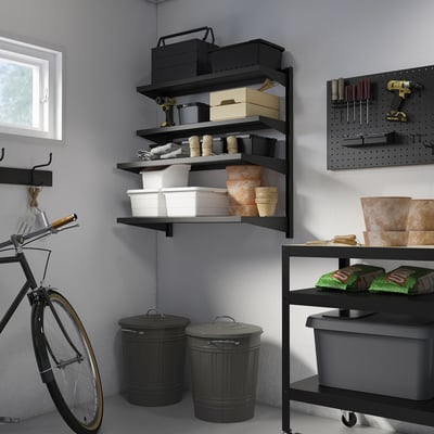 Garage with BROR shelves, tools & supplies. Bike leans, pegboard on right.