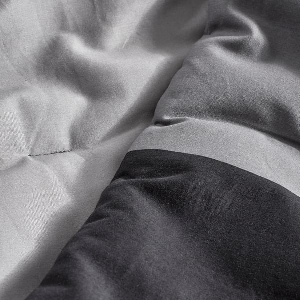 Close-up of soft, high-quality comforter fabric, showcasing its smooth texture and fine weave.
