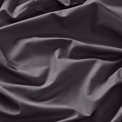 Close-up of soft, draped grey cotton fabric, showcasing its smooth texture and quality.