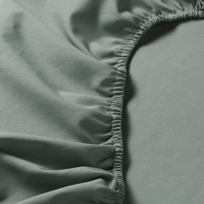 Close-up of smooth, high-quality fabric with even stitching. Soft cotton texture, neatly gathered edges.