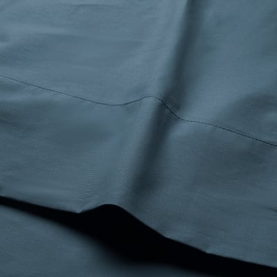 Dark blue fabric with seams, appears soft and well-finished, likely high quality.