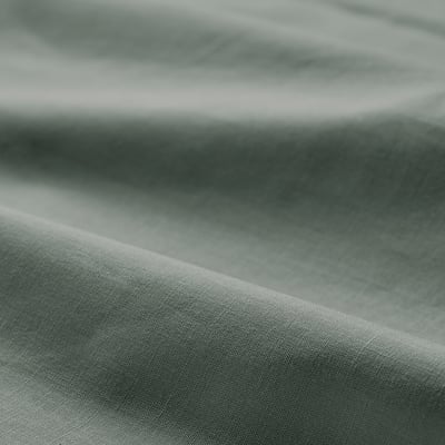 Close-up of smooth, greenish-grey fabric; soft, textured cotton quality.