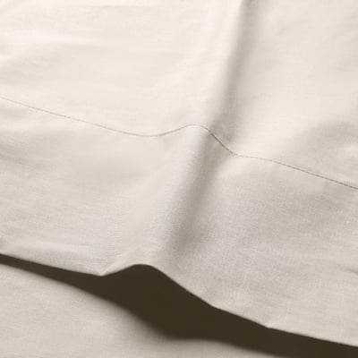 Smooth, light-colored fabric, neatly stitched, likely cotton, folded gently.