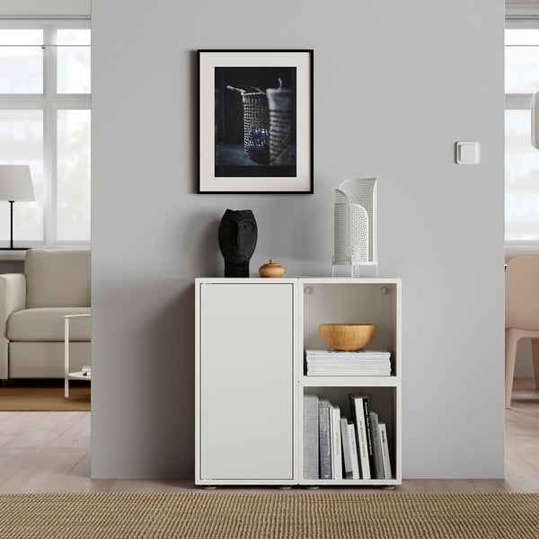 Modern living room with EKET storage unit, books, & decor.