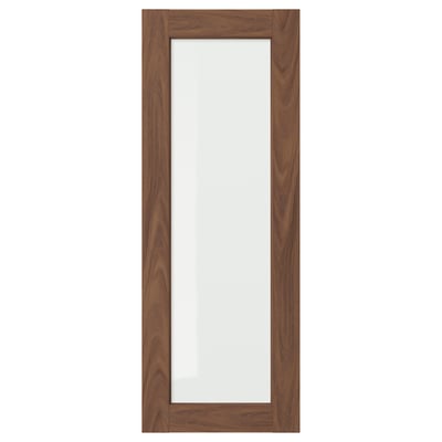The ENKÖPING cabinet door in brown walnut. It has a wooden frame with a glass centre, adding a classic and elegant touch.