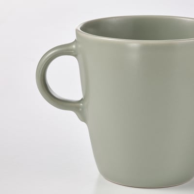 Sleek, modern matte green mug with comfortable handle. Ideal for coffee or tea.