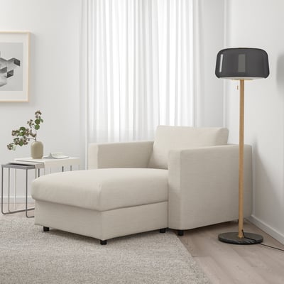 Modern living room with FINNALA off-white sectional sofa, sleek floor lamp, minimalist decor. Sofa is spacious, fitting well with other items.