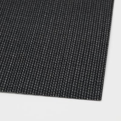 Close-up of woven black plastic place mat, showcasing its textured, durable surface.