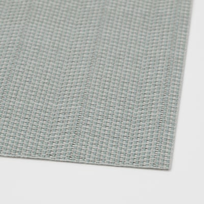 Blue and white woven plastic place mat, neatly folded, showing intricate pattern and clean edges.