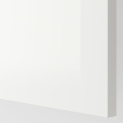 Image shows a smooth, glossy white surface, likely a cabinet door, reflecting light softly.