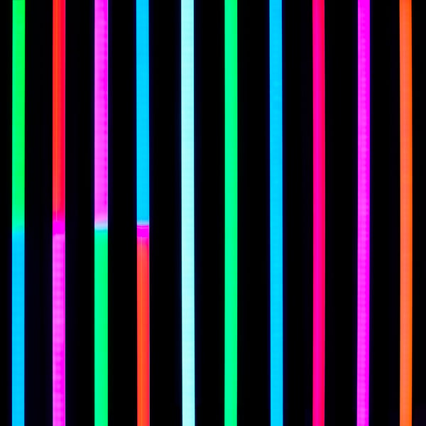 Vertical stripes of vibrant colours against black, showcasing sleek, playful design of FÖRLIG lamp.