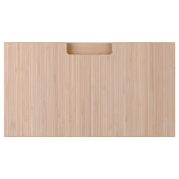 A rectangular wooden drawer front in natural bamboo colour with integrated handles.