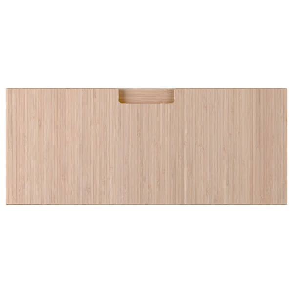 Depicts a light-colored wooden drawer front with a handle. It is made of bamboo, featuring a clean, modern design.