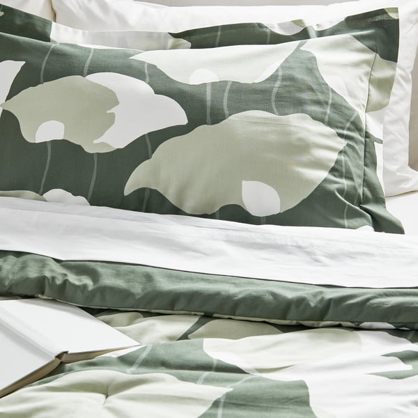 Luxurious bedding set with smooth, floral-patterned comforter and matching pillow sham in green and white hues.