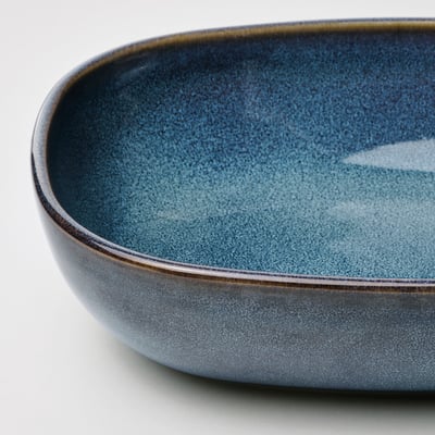 Crafted glazed bowl, deep blue with gleaming golden rim, robust yet elegant.