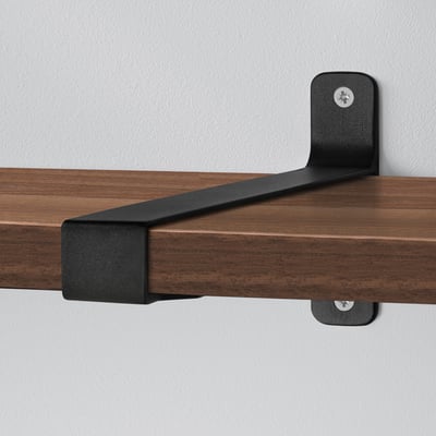 Shelf bracket securely fastened to wooden shelf.