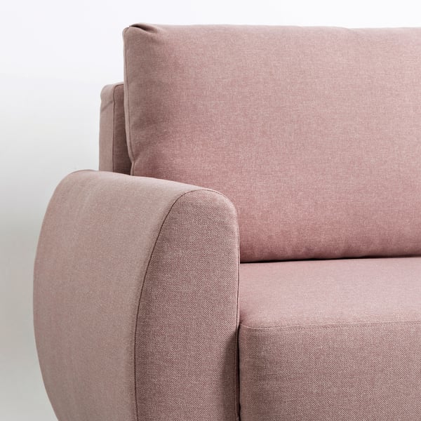 A close-up of a modern pink sofa with clean lines and plush cushions, showcasing quality upholstery and design.